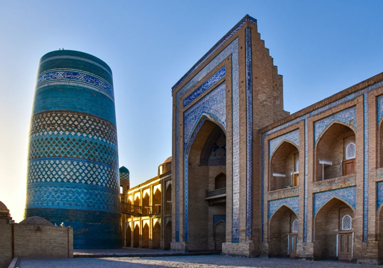 a blue and beige building next to a tall bulding