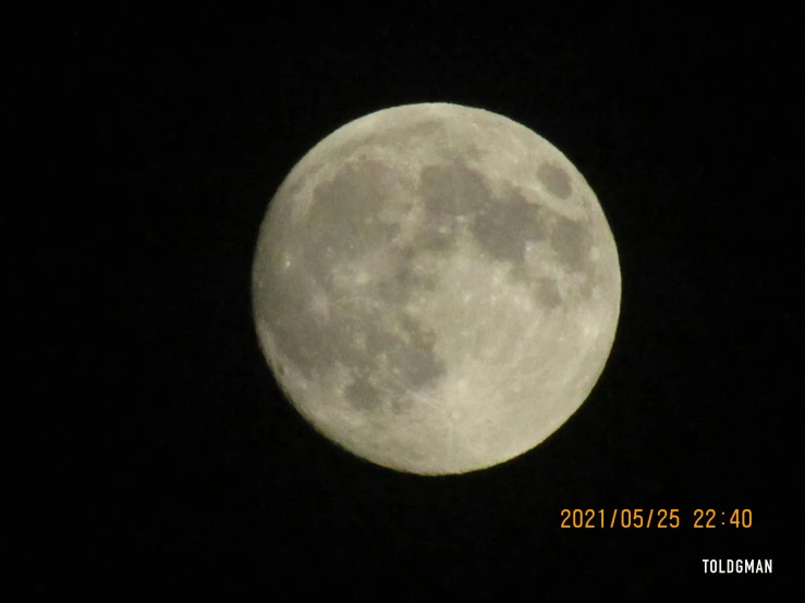 the full moon seen at night in the dark sky