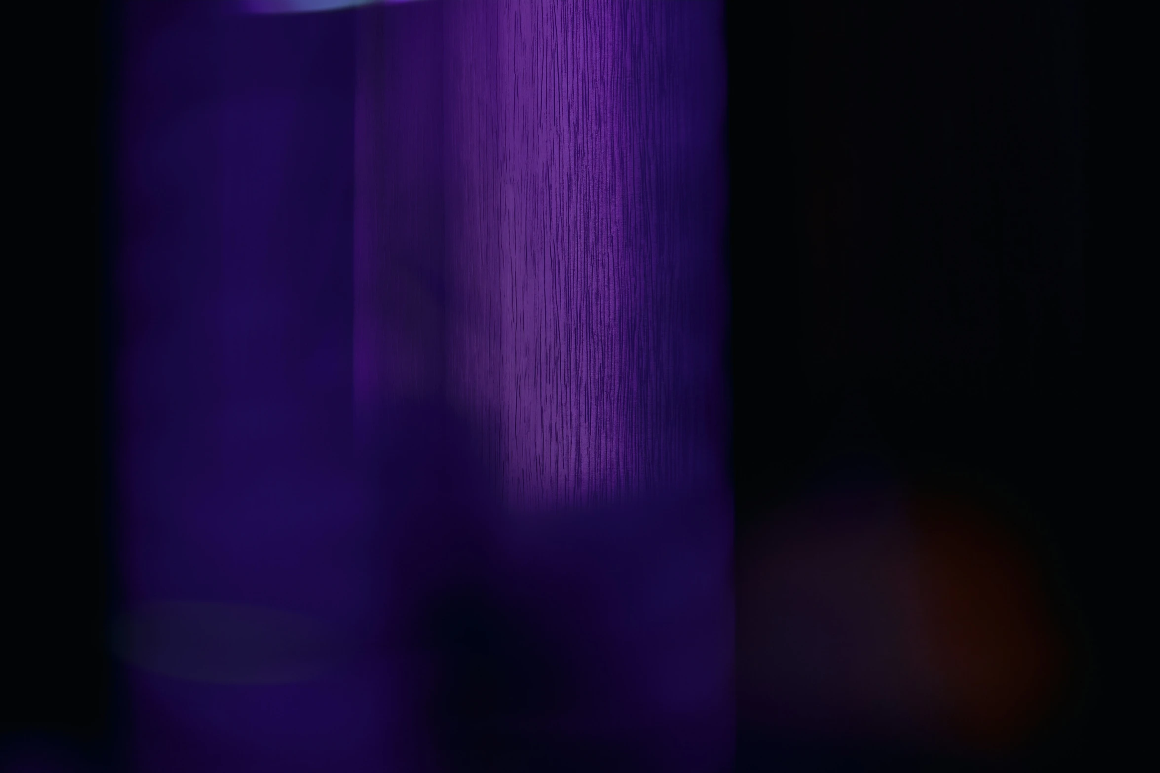 a purple object against a black background