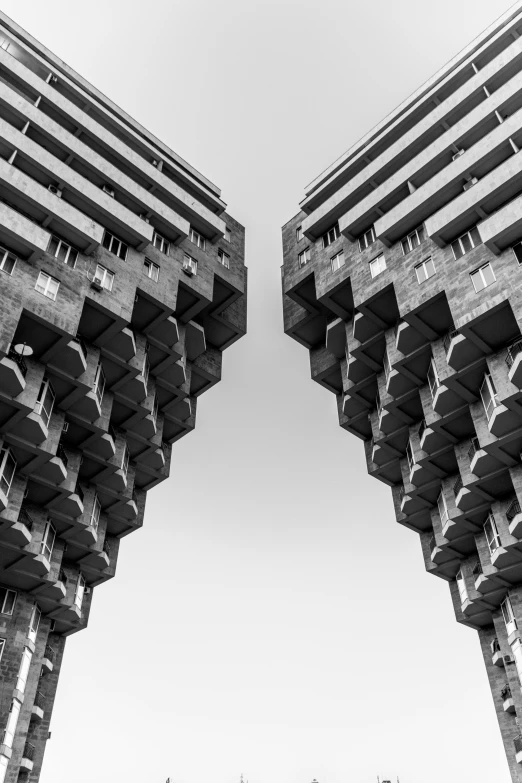 two black and white buildings with windows that appear to be upside down