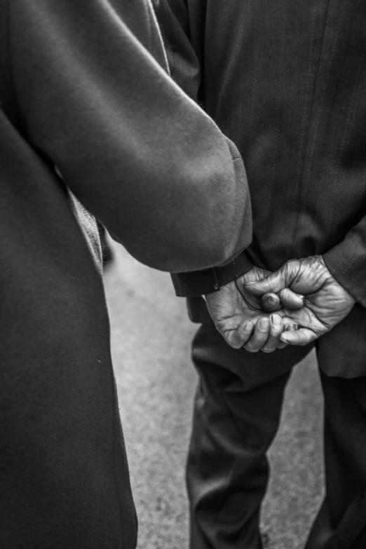 black and white po of an elderly couple holding hands