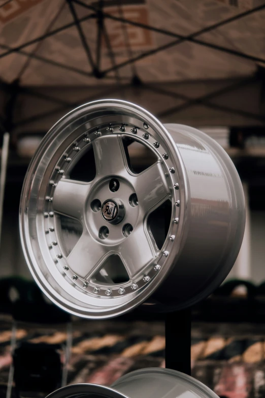 a wheel sits on display in front of a building