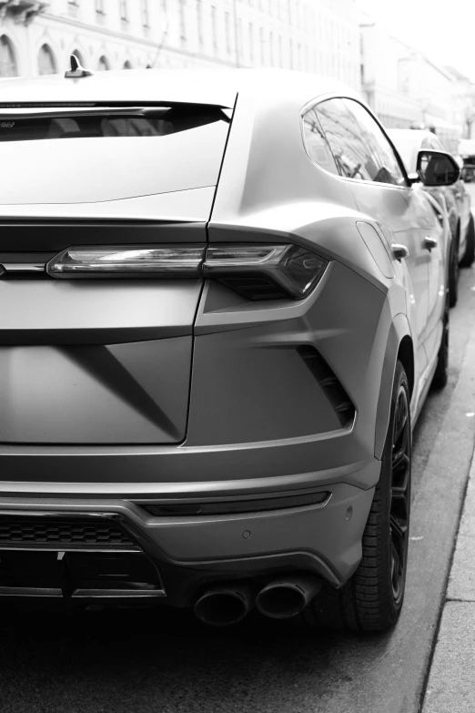 a black and white pograph of a car on the side of the road