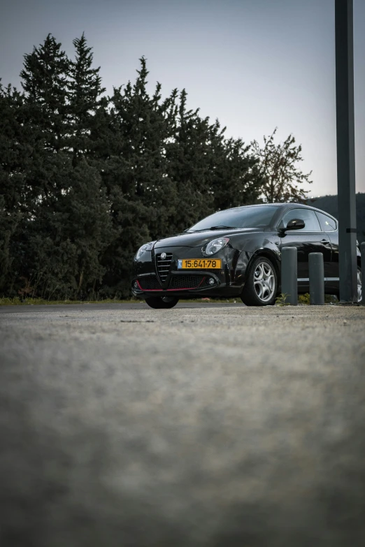 a silver sports car parked near some trees