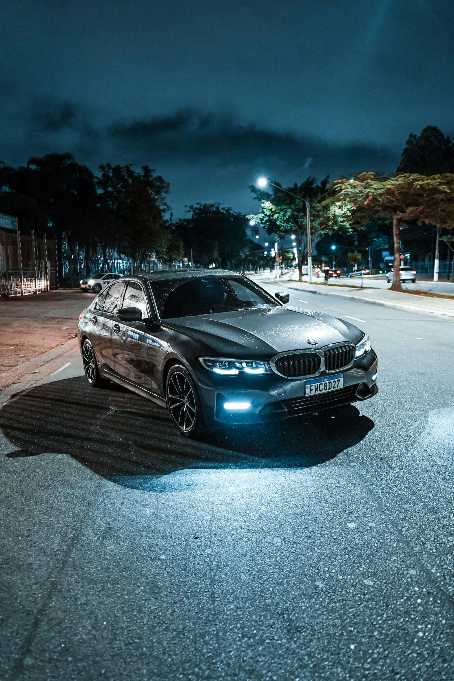 a dark bmw parked in the middle of the street