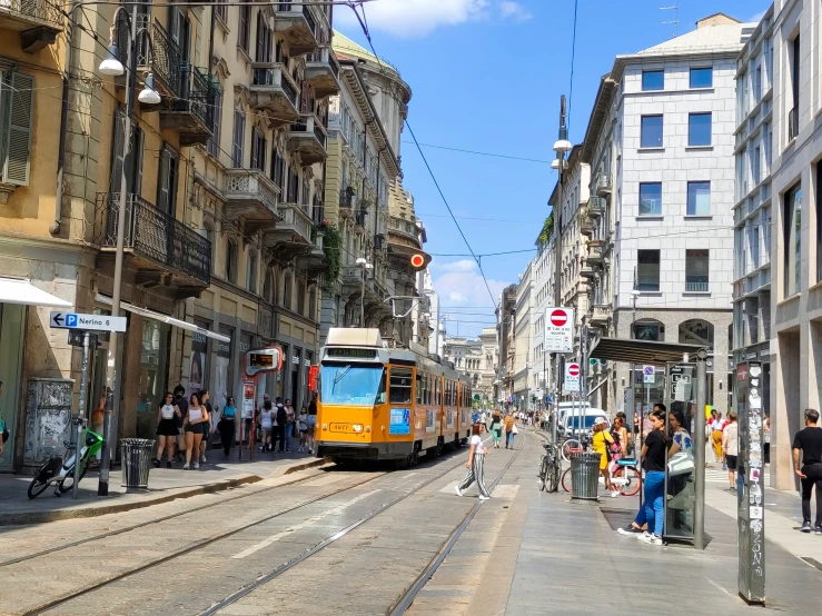 a street with a bus and people walking on it