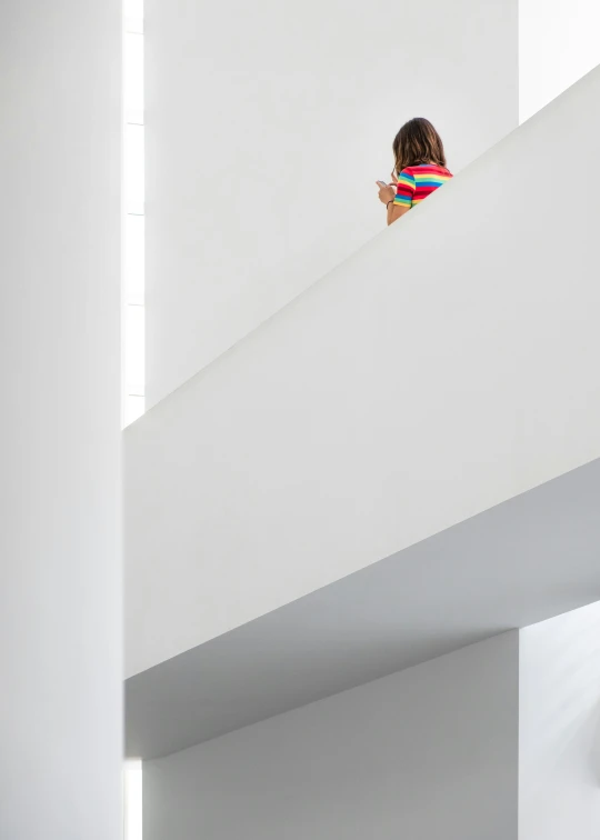 woman taking selfie from the bottom floor of a building