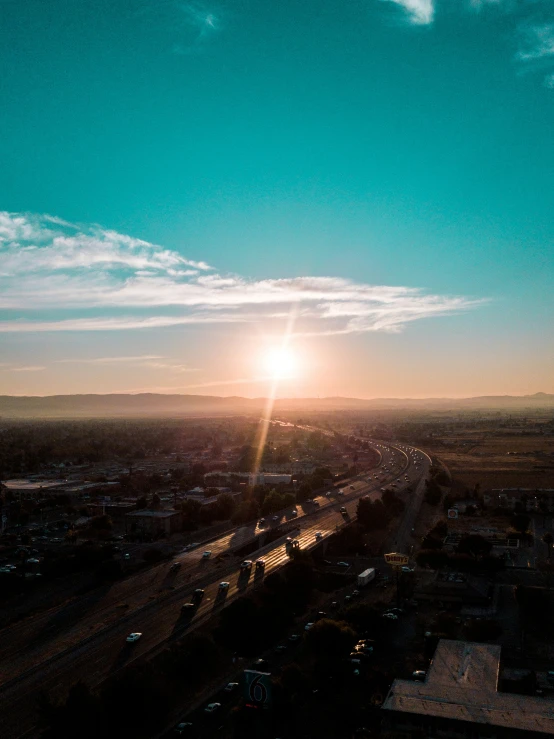 the sun sets on an otherwise empty highway