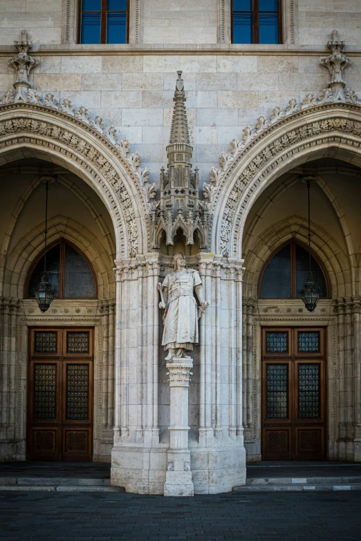 a statue standing in front of a building