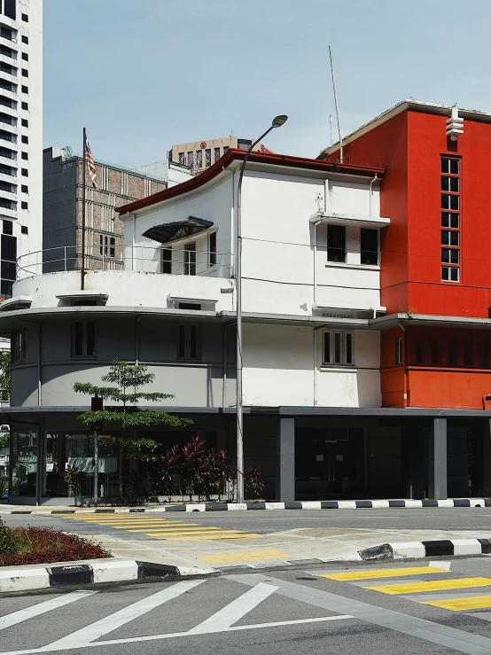 this is a white and red building surrounded by tall buildings