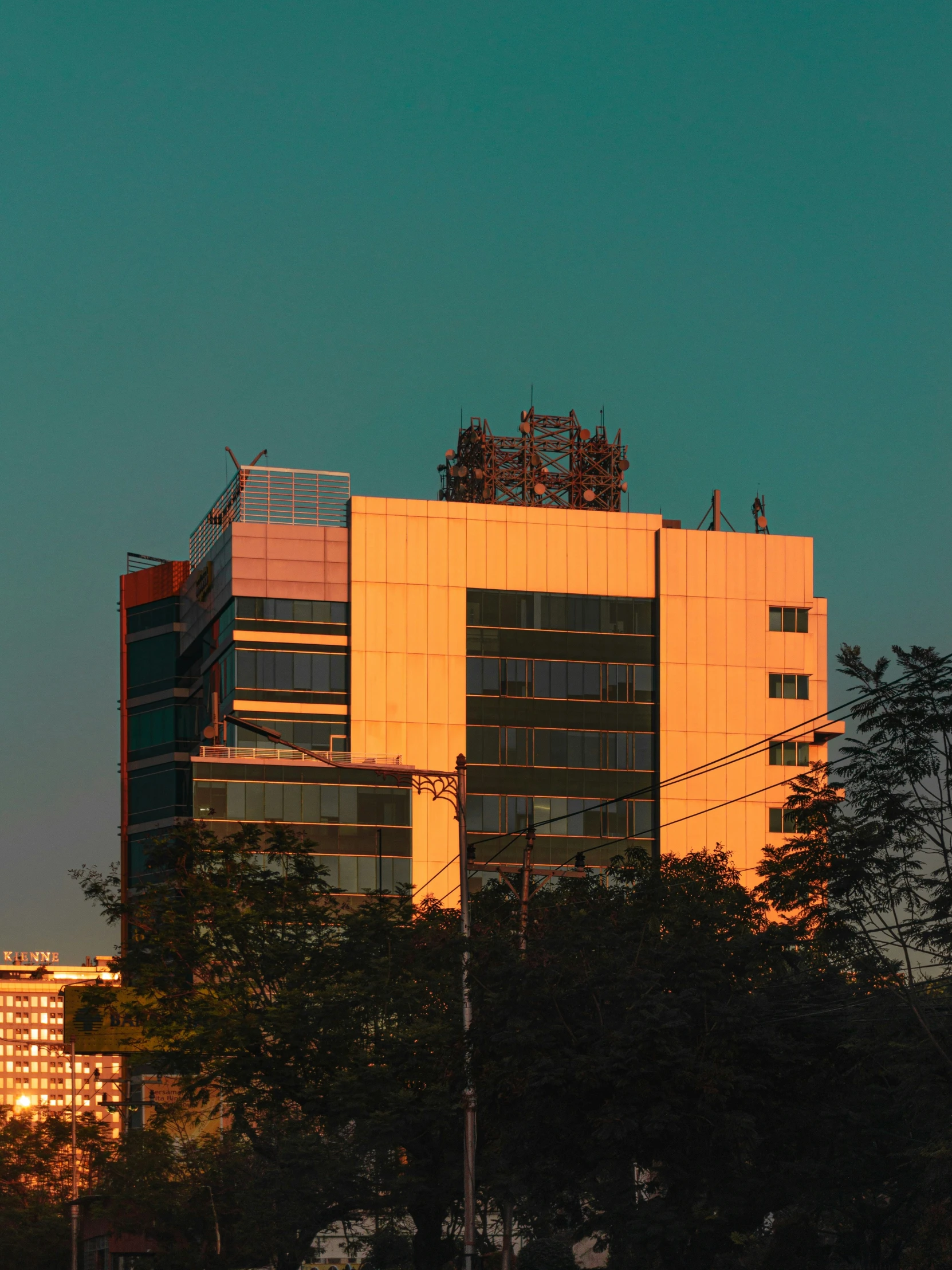 a building with a very tall tower is seen at night