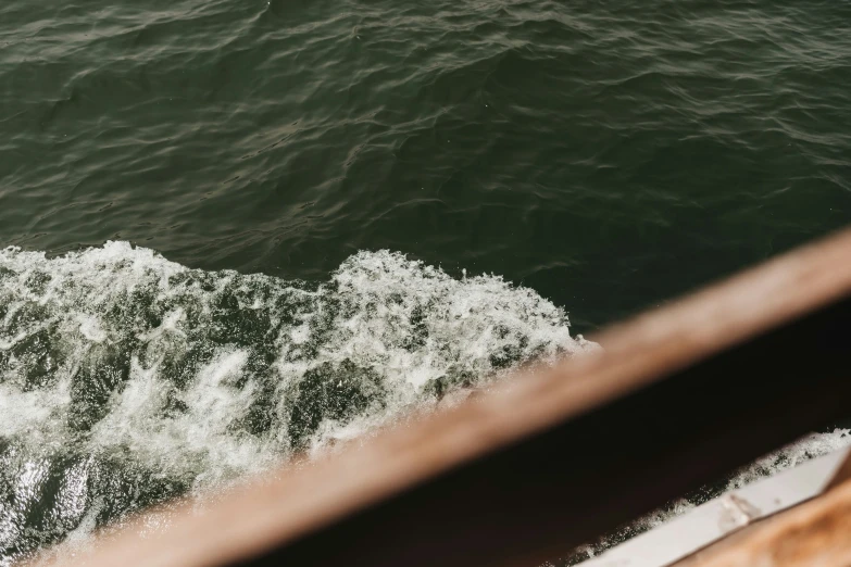 the white foam is breaking off of a boat's wake