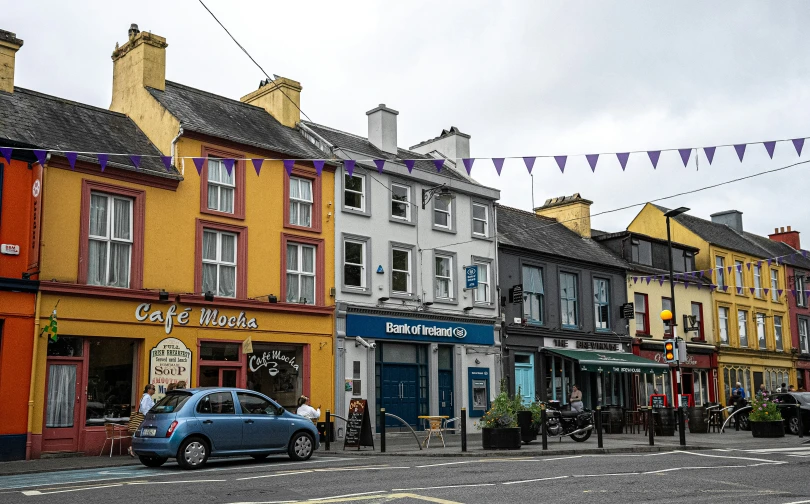 a group of people and cars are on a street