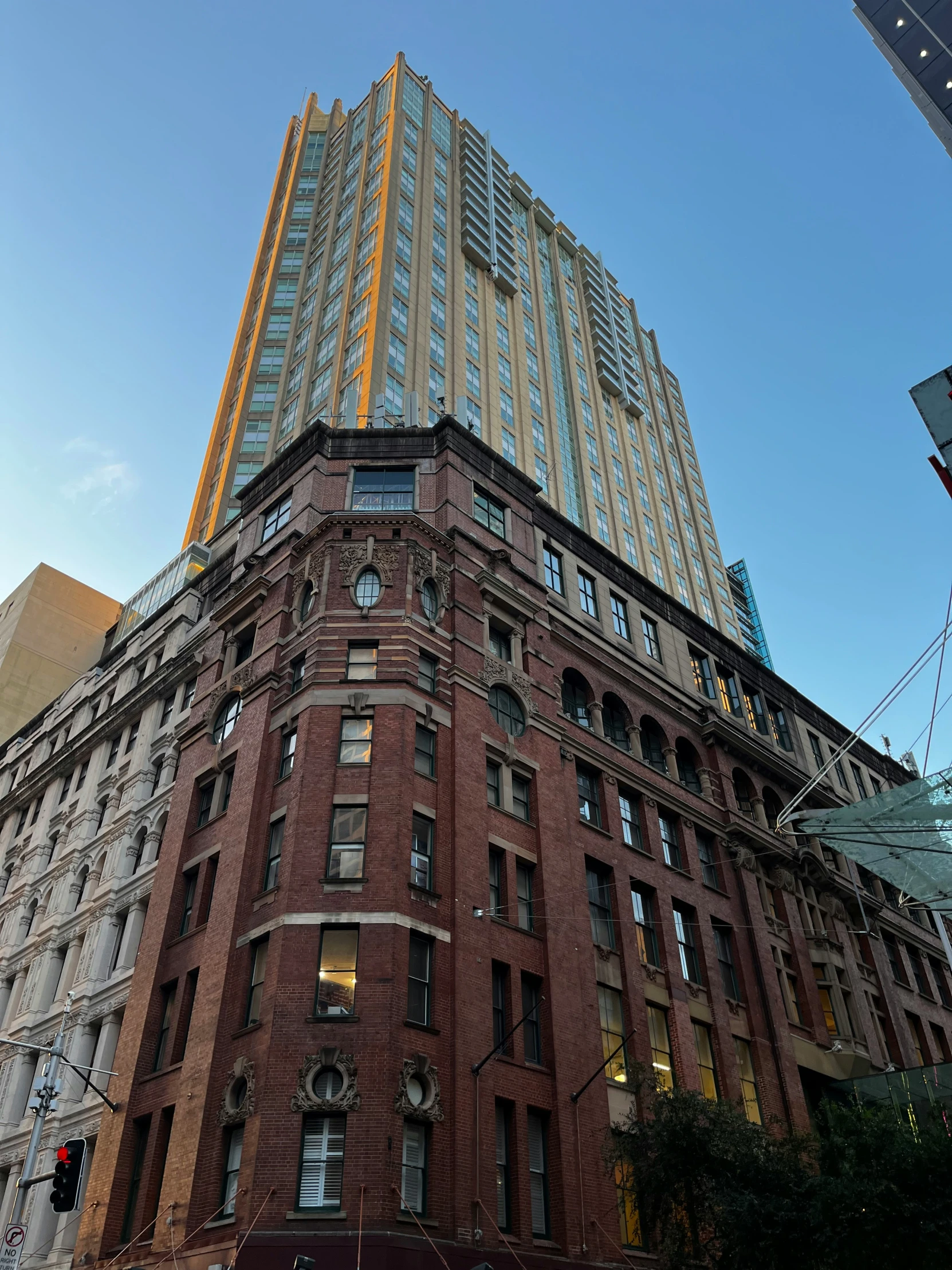 a building stands against a blue sky in the city