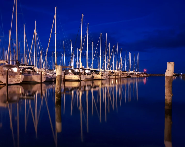 many small sailboats moored in a harbor