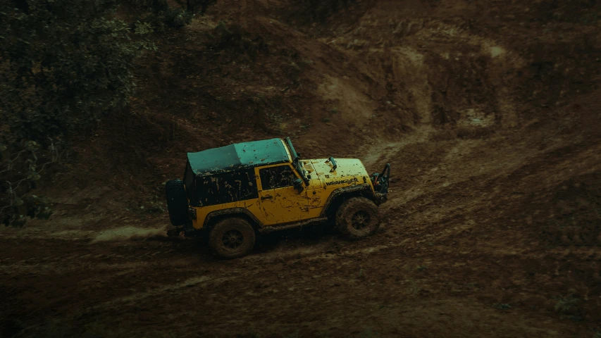 the jeep is stuck in the mud and it has green top