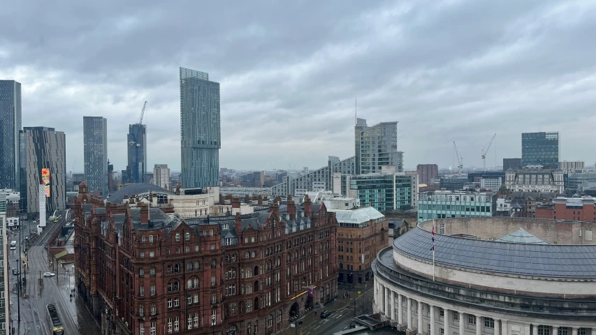 buildings line a street in the distance behind a cloudy sky