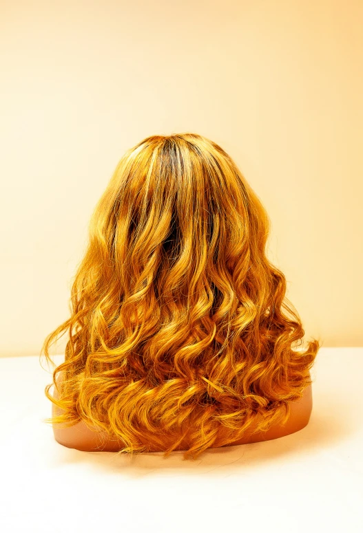 long, curly yellow hair lying across the back