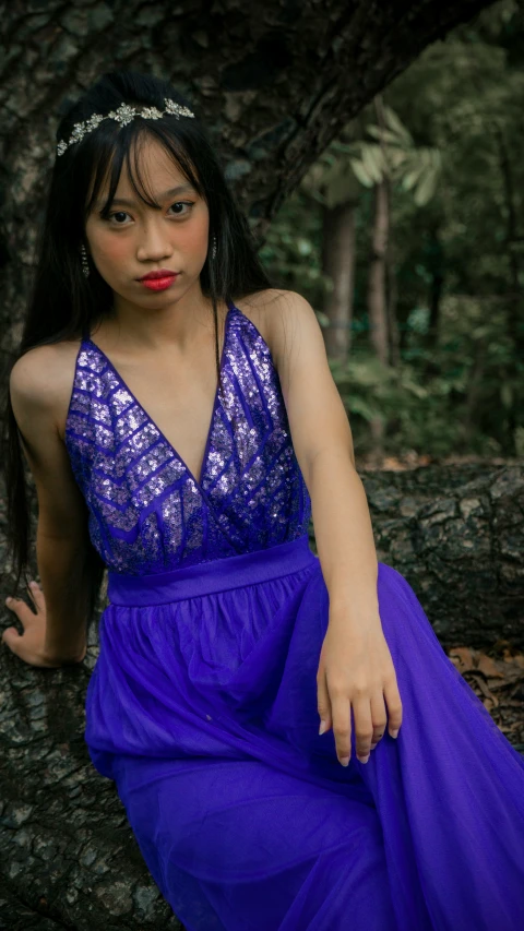 a woman in blue dress posing for a po