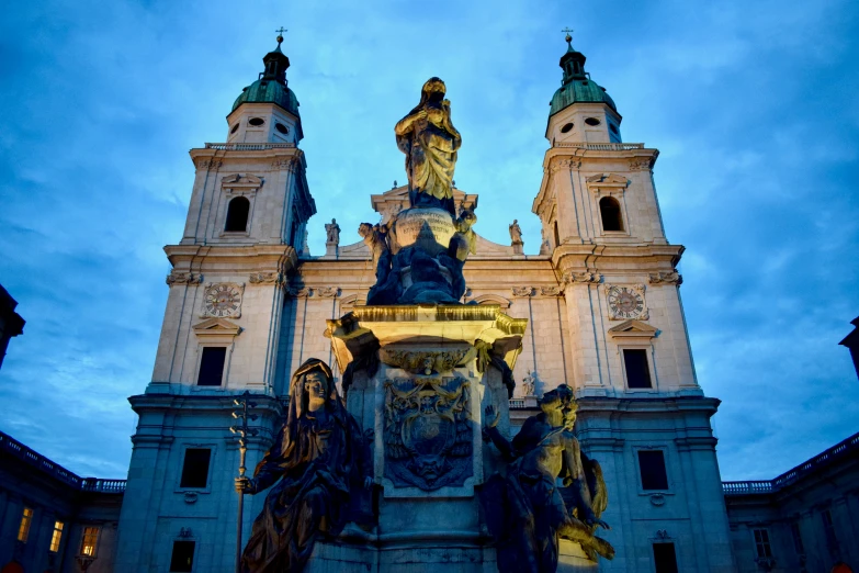 the building has two towers and statues on the top of it