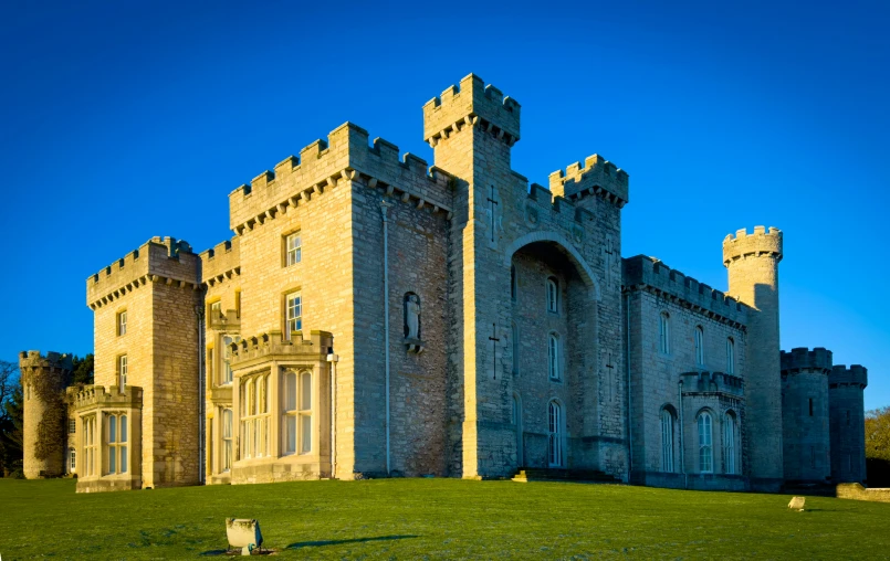 large castle like structure on green grassy field