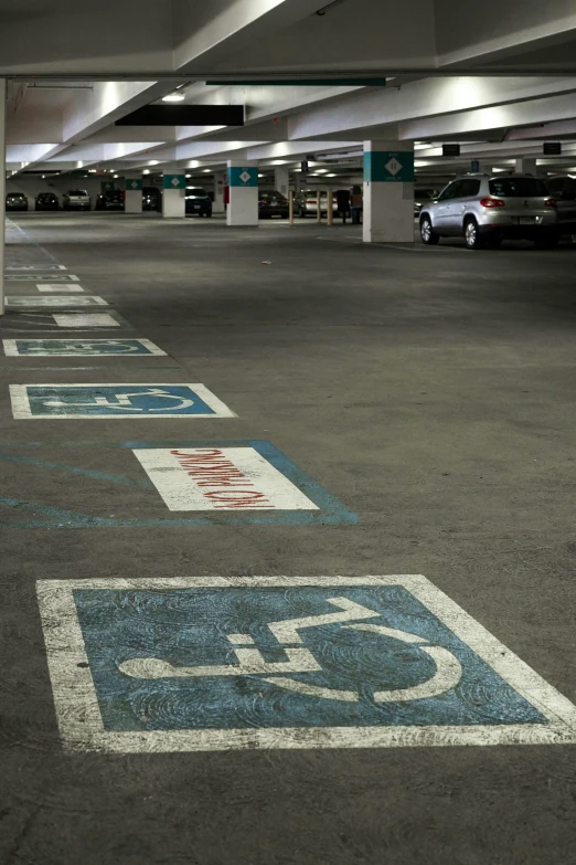 parking spaces are painted blue and white in this parking garage