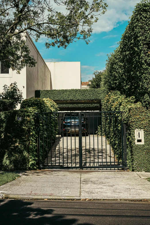 a gate is set between two buildings on the sidewalk