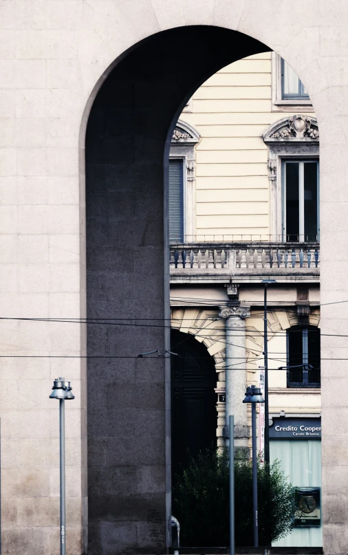 view from the road through an arch and gate at the intersection of a street