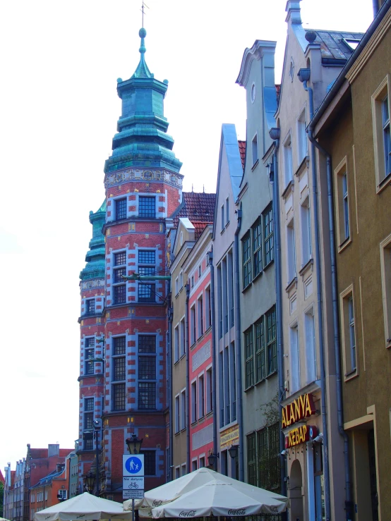 several large buildings in the city with a green cupola