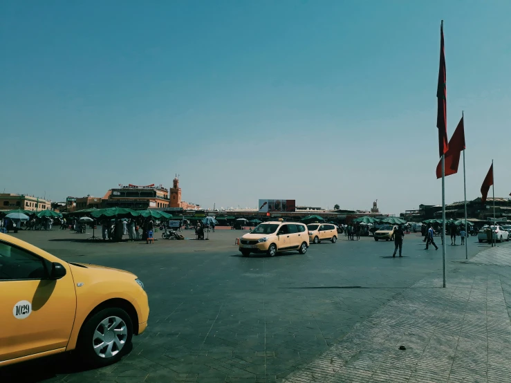 several cars are parked near a busy street