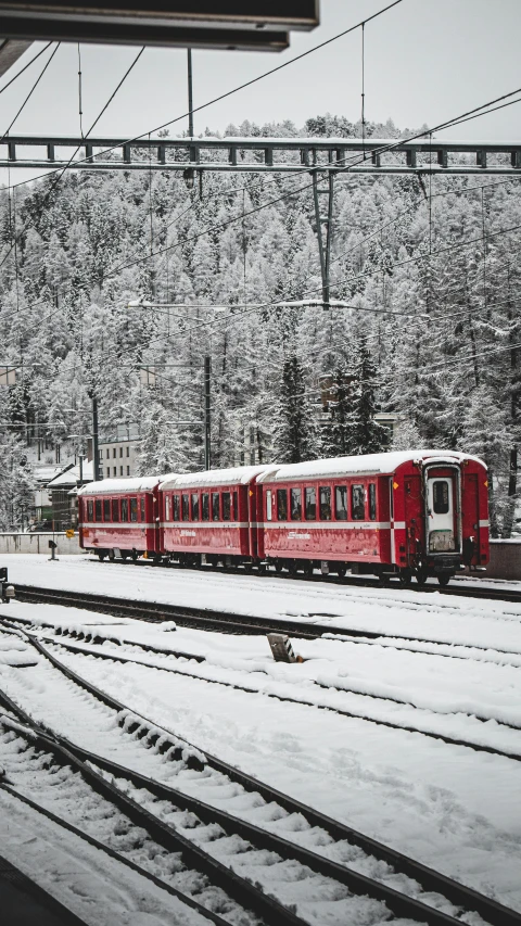 two train tracks next to each other and one in snow