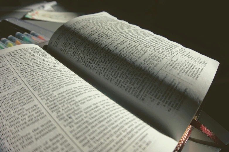 a close up of an open book and crayons on a table