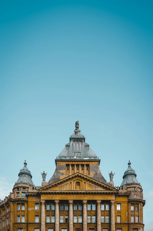 a very large yellow building with a clock tower