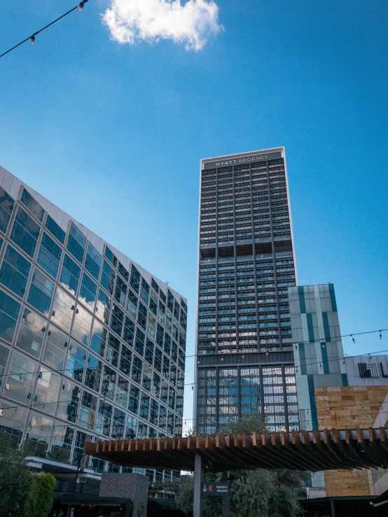 the side of several buildings and a pedestrian bridge