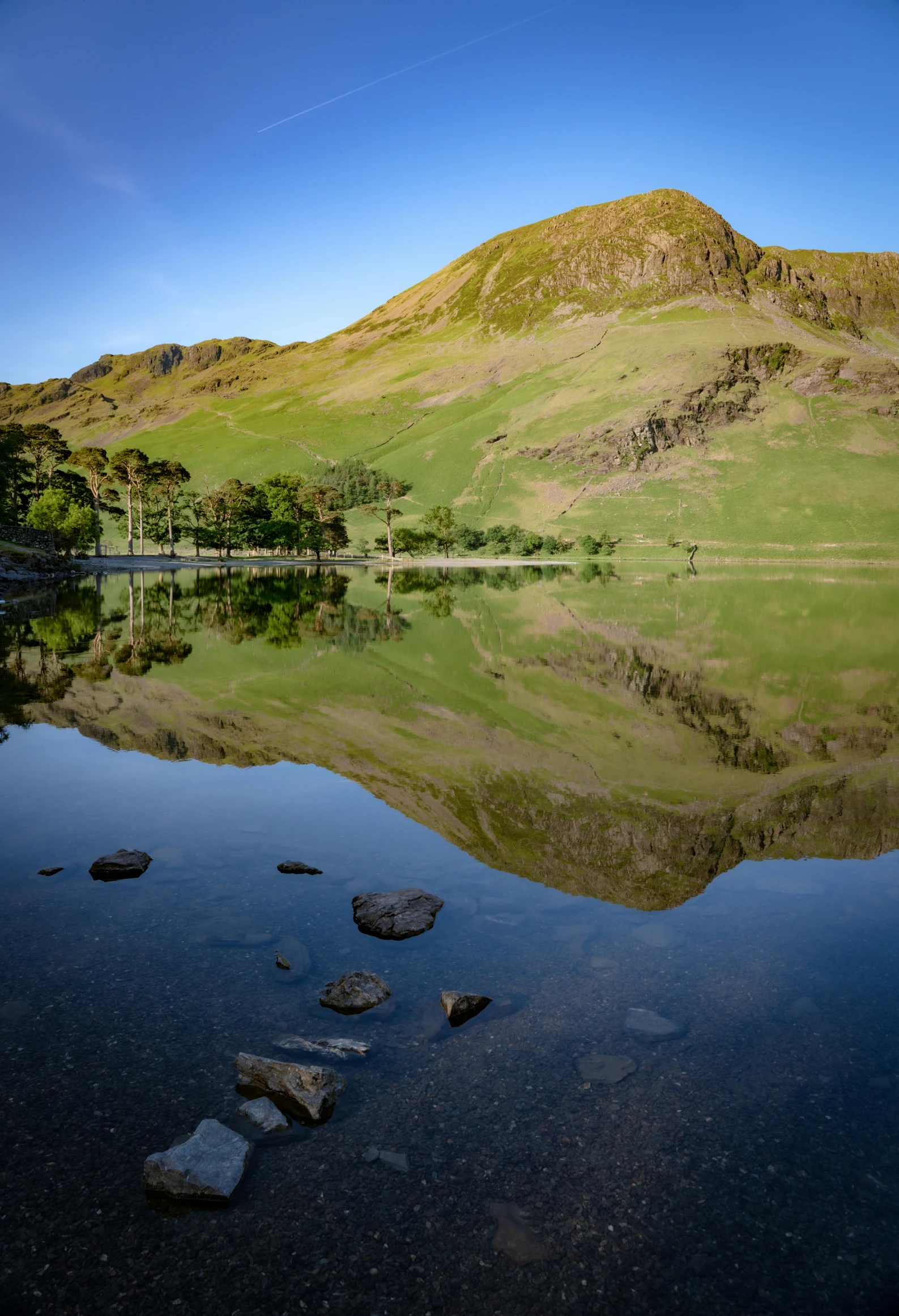 a mountain is in the distance with a lake and mountains