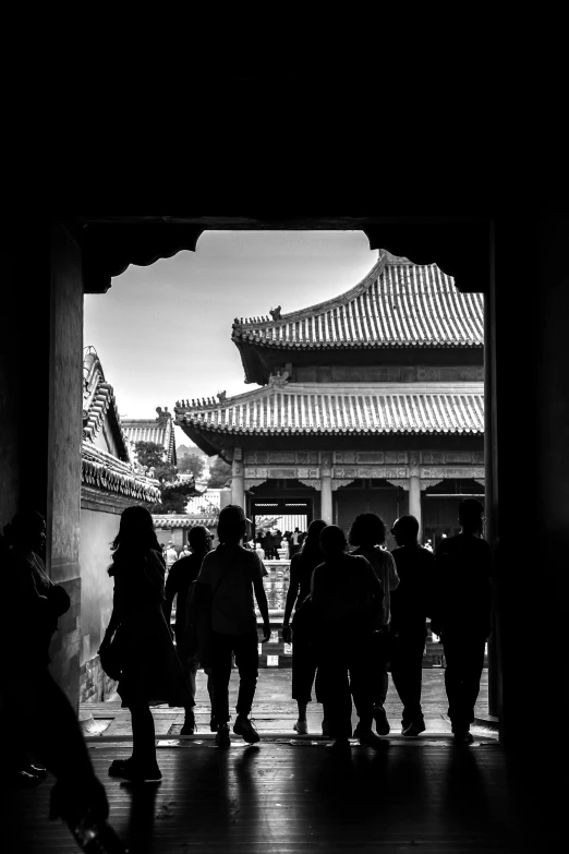 black and white pograph of people walking in the forbidden city