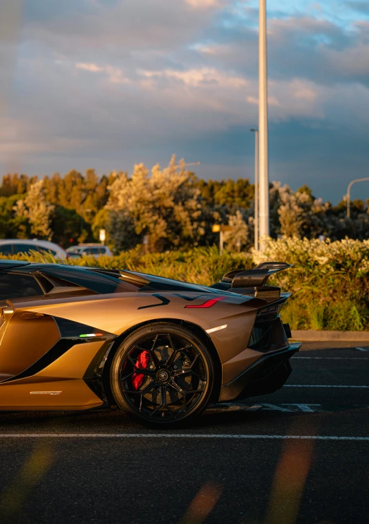 an exotic car with a top down parked in a parking lot