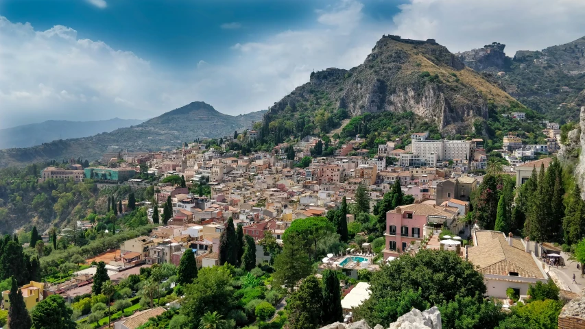 a city and mountain surrounded by trees