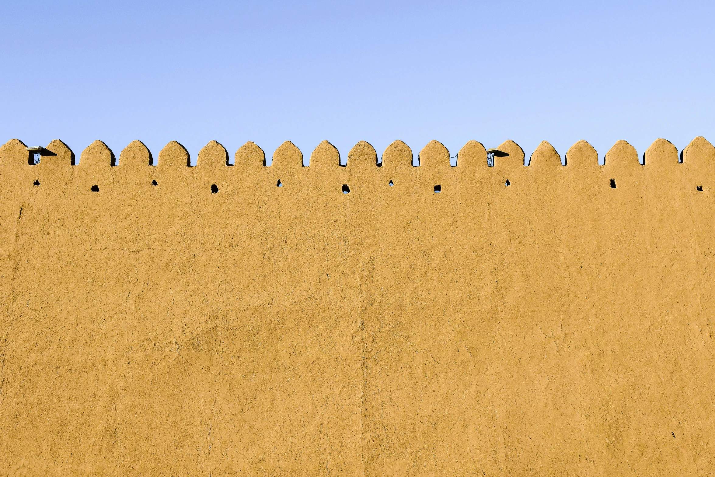 a big, sand dune with some grass growing between it