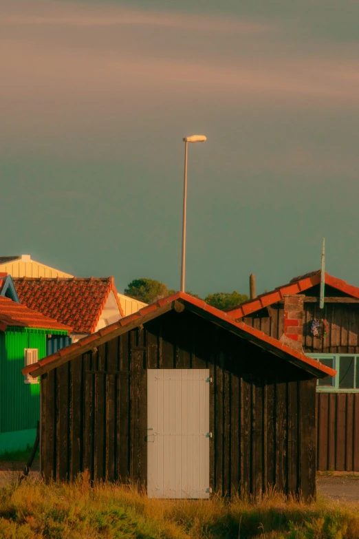 some little houses sitting in a field near one another