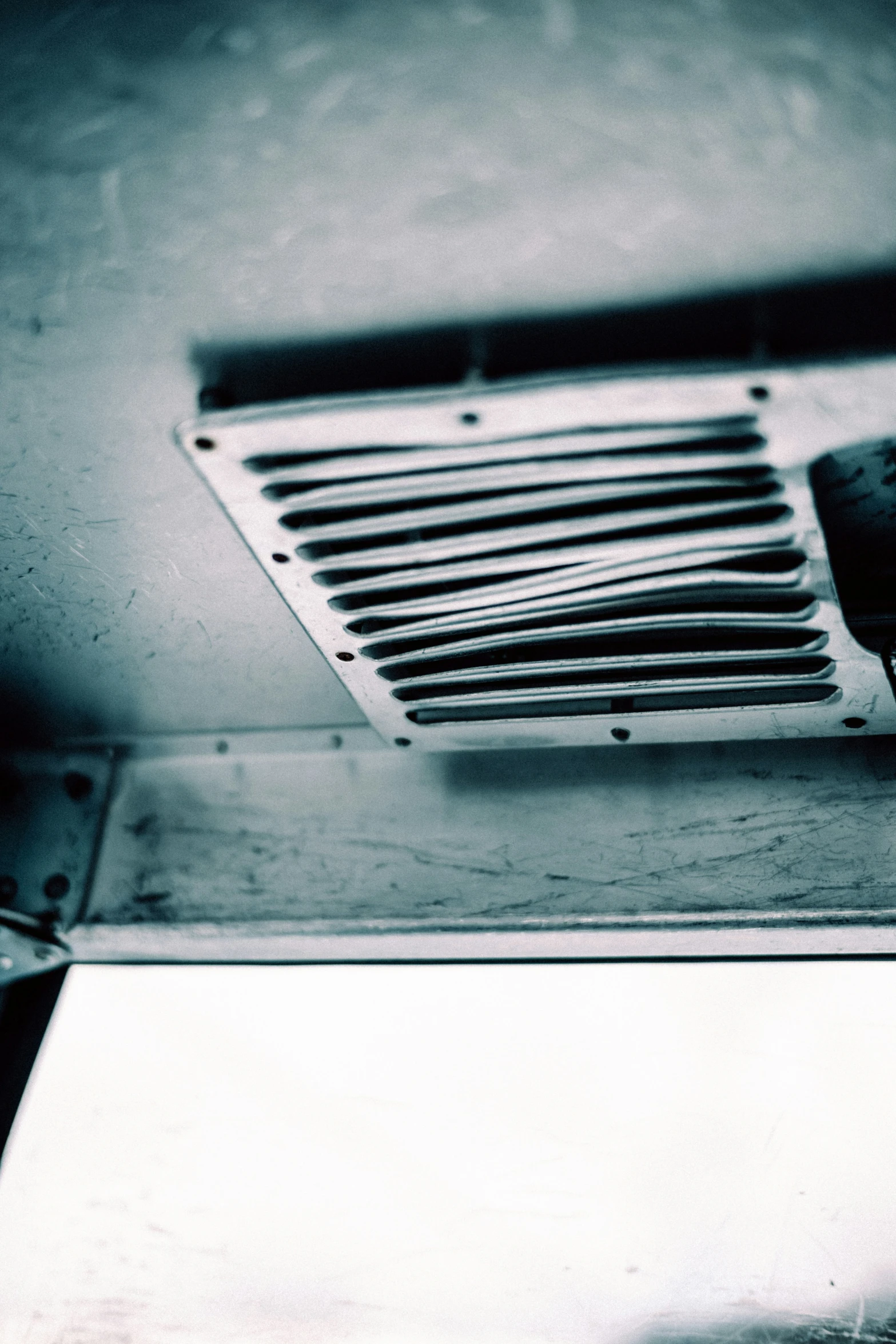 a fan is mounted on the wall next to an old cell phone