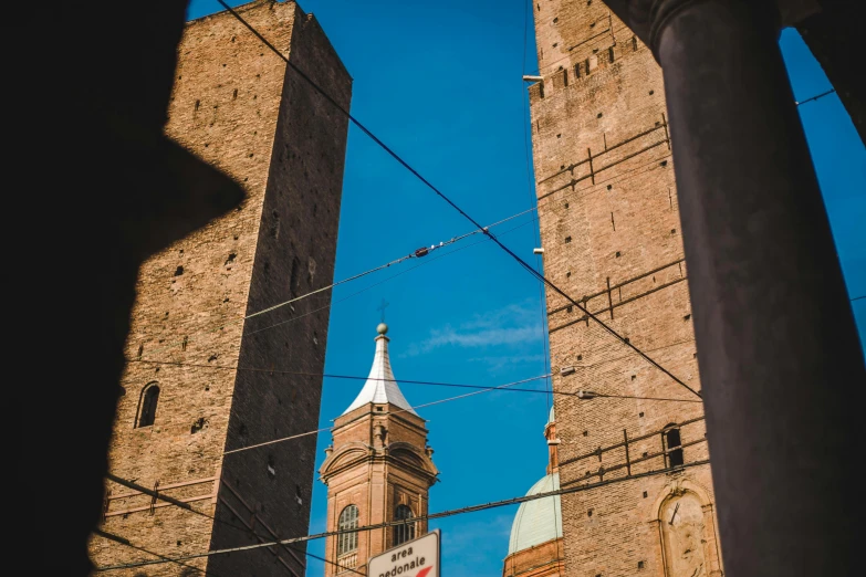 two tall towers sitting under a blue sky