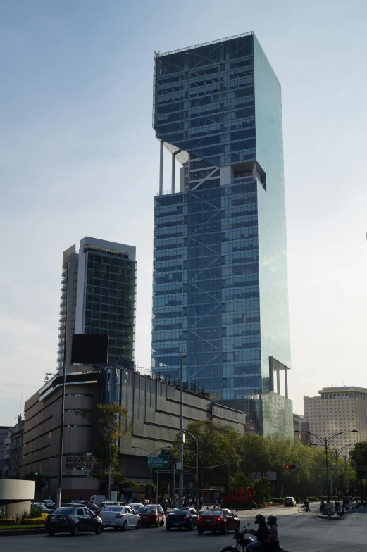 two tall skyscrs next to a street intersection