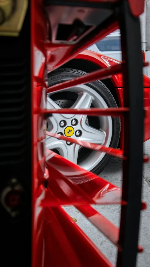 the wheel on a red car in front of a white van