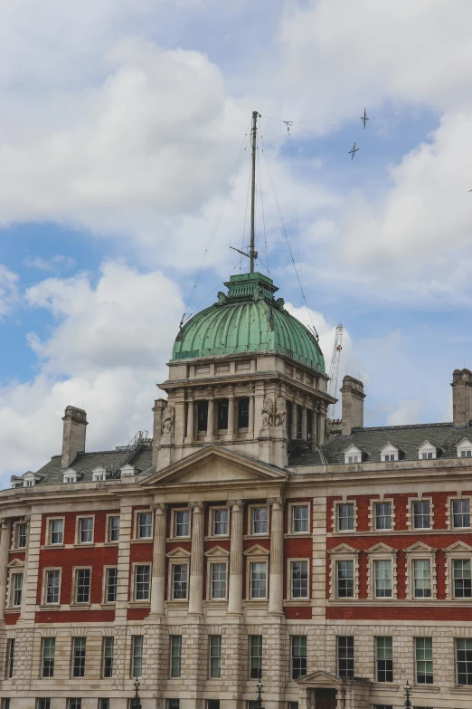 an old building has a green roof and dome