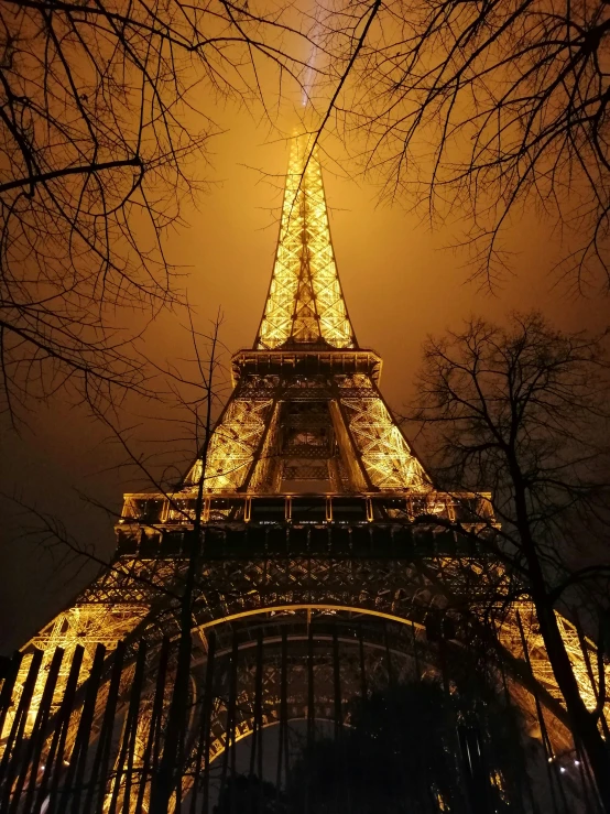 the eiffel tower is lit up in the night