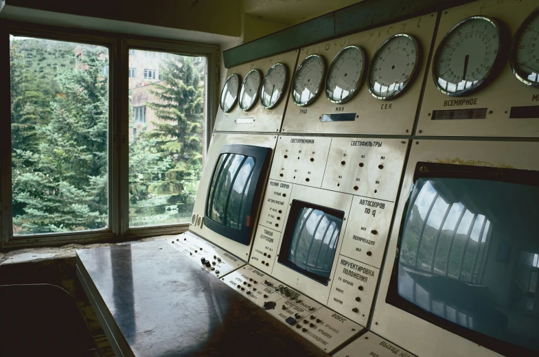 a control panel is shown near a window with multiple clocks