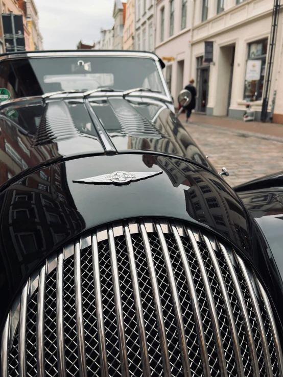 a car parked on the street in front of an old building