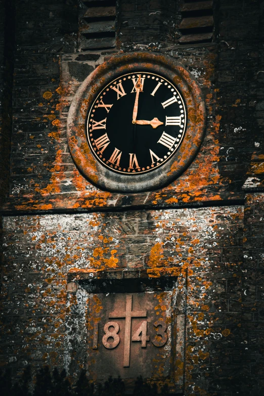 there is a clock in an old building with rusted paint