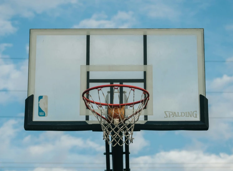 a basketball is going through the net of a basketball hoop